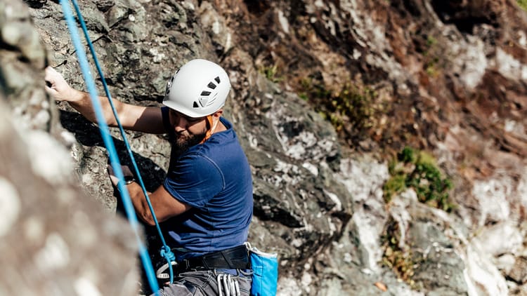 man-climbing-a-steep-rock-formation-with-climbing-2026-01-11-10-11-11-utc.jpg